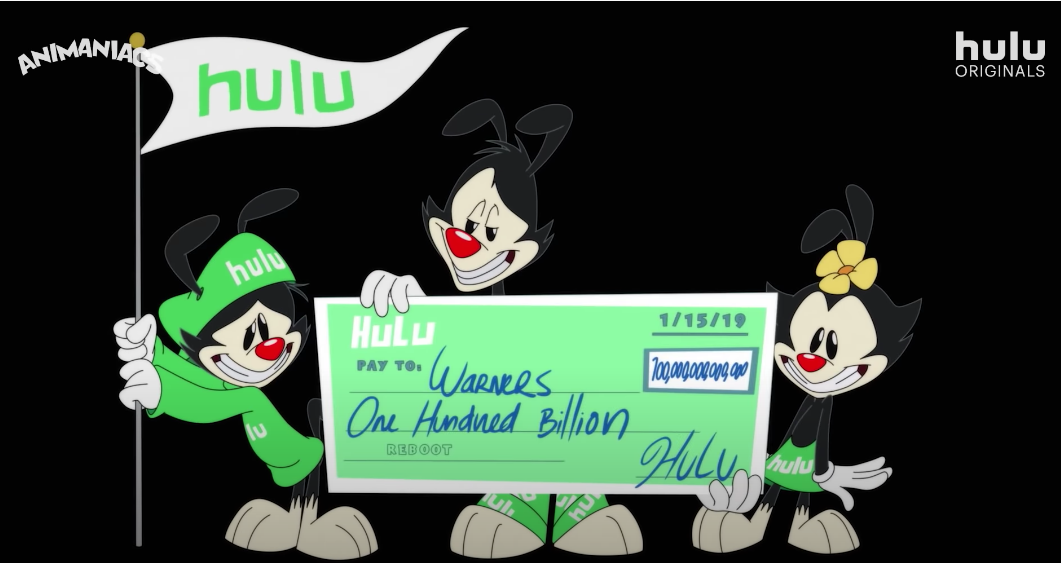 The Warners holding a giant Hulu check while dressed in Hulu merch