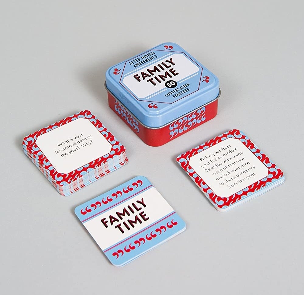 a blue and red tin with &quot;family time&quot; written on it and an array of cards with questions to answer