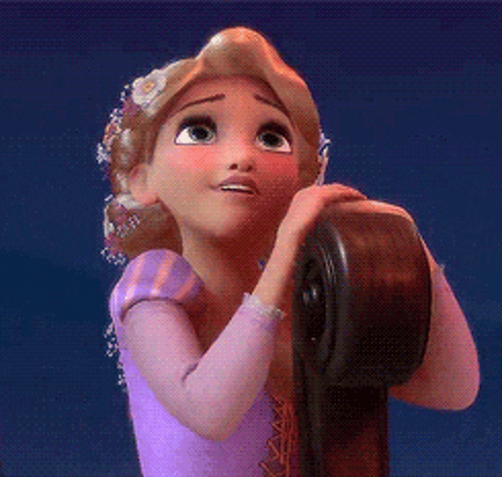 a gif of rapunzel longingly looking into the sky while on a boat in the movie tangled