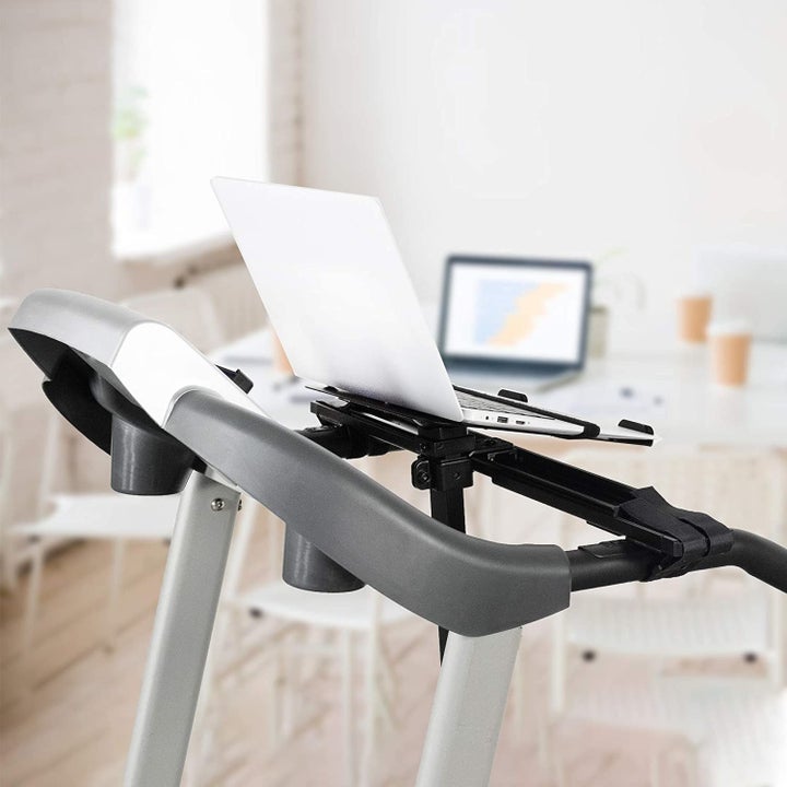 A laptop secured on an attachment on a treadmill