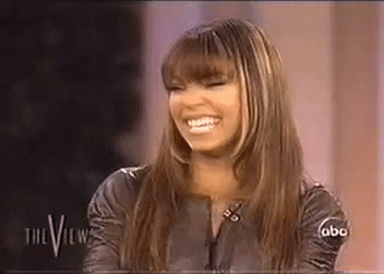 A GIF of Ashanti laughing on The View