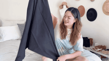 A gif of a tester holding up the jumpsuit.