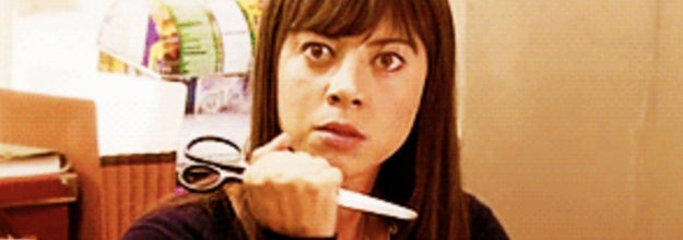 Image of woman holding scissors.