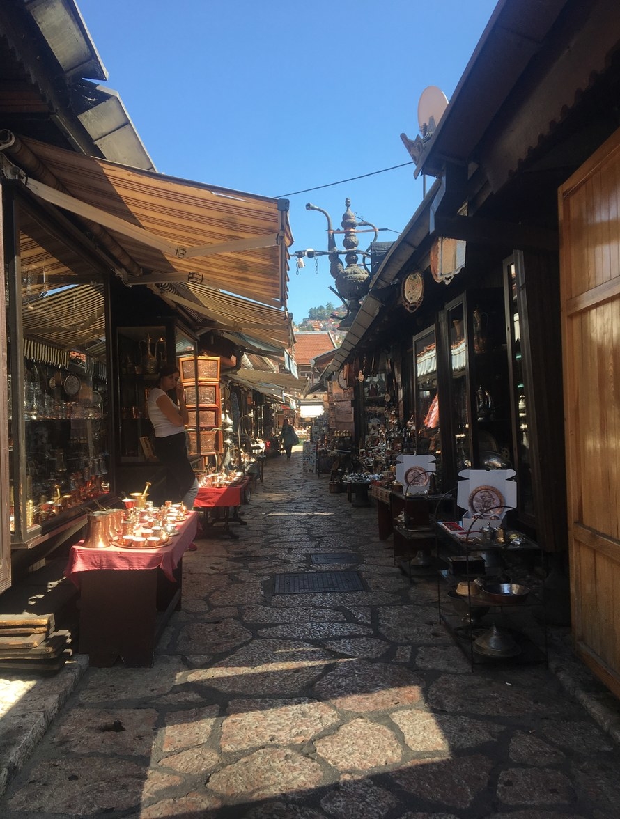 A gorgeous, cobblestone street with wares being sold along the side