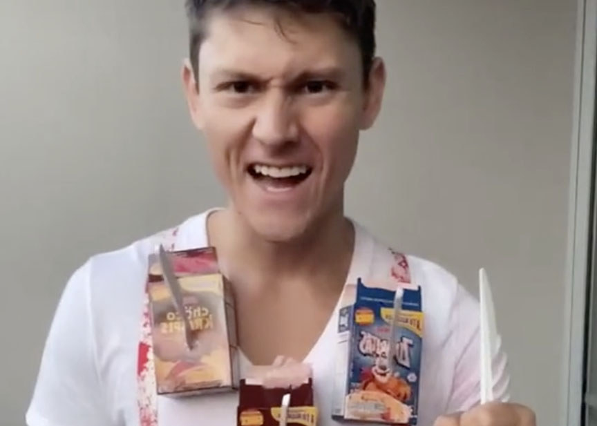 A man wears a shirt cereal boxes taped to it 