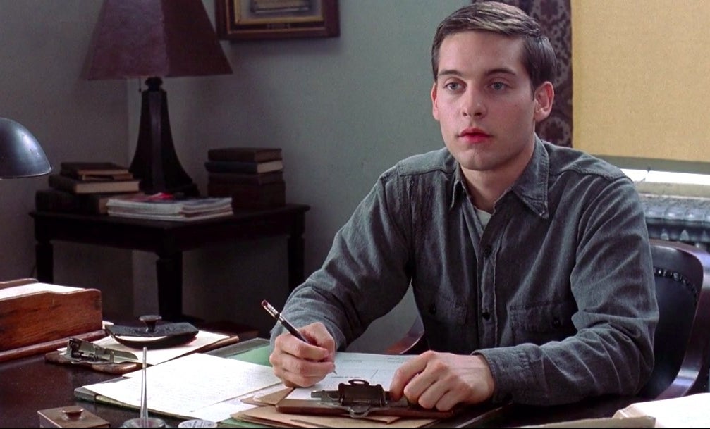 tobey maguire sitting at a desk in &quot;the cider house rules&quot;