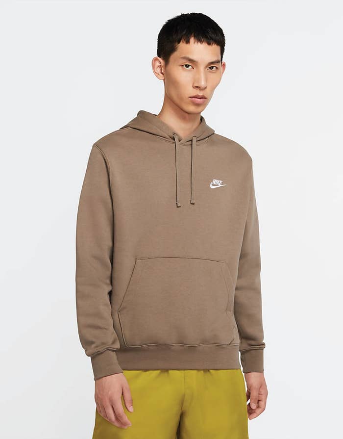 A model wearing the men&#x27;s hoodie in light brown