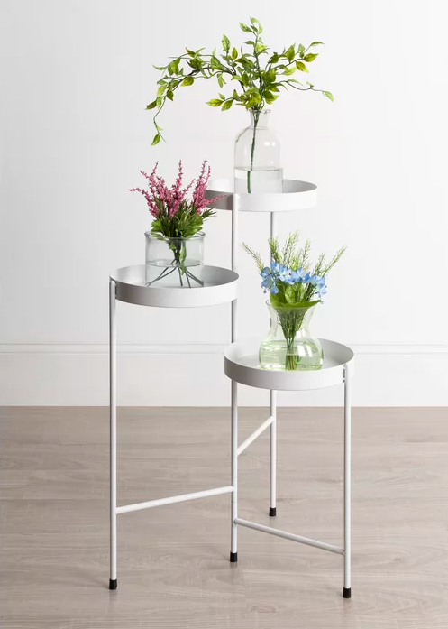 the plant stand in white with three plants on it