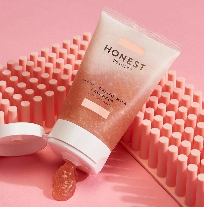 a clear bottle with pink cleanser labeled &quot;Honest Beauty&quot;