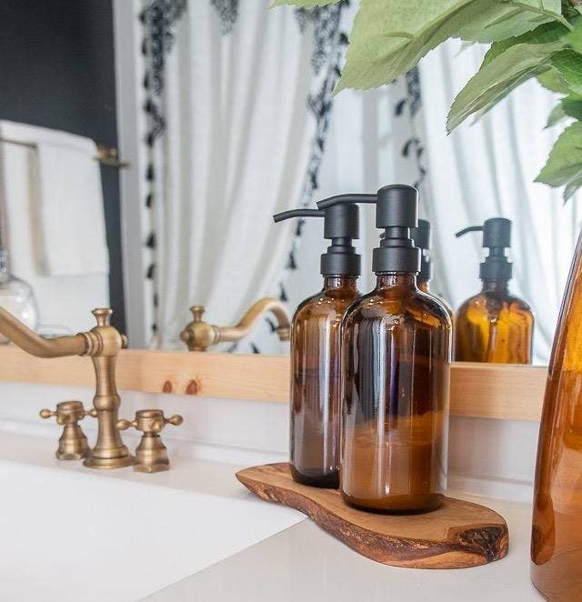 The bottles with black pumps on a bathroom counter
