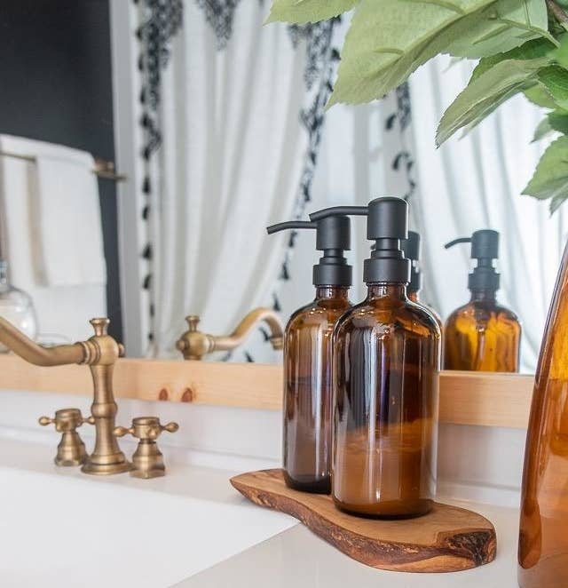 The bottles with black pumps on a bathroom counter
