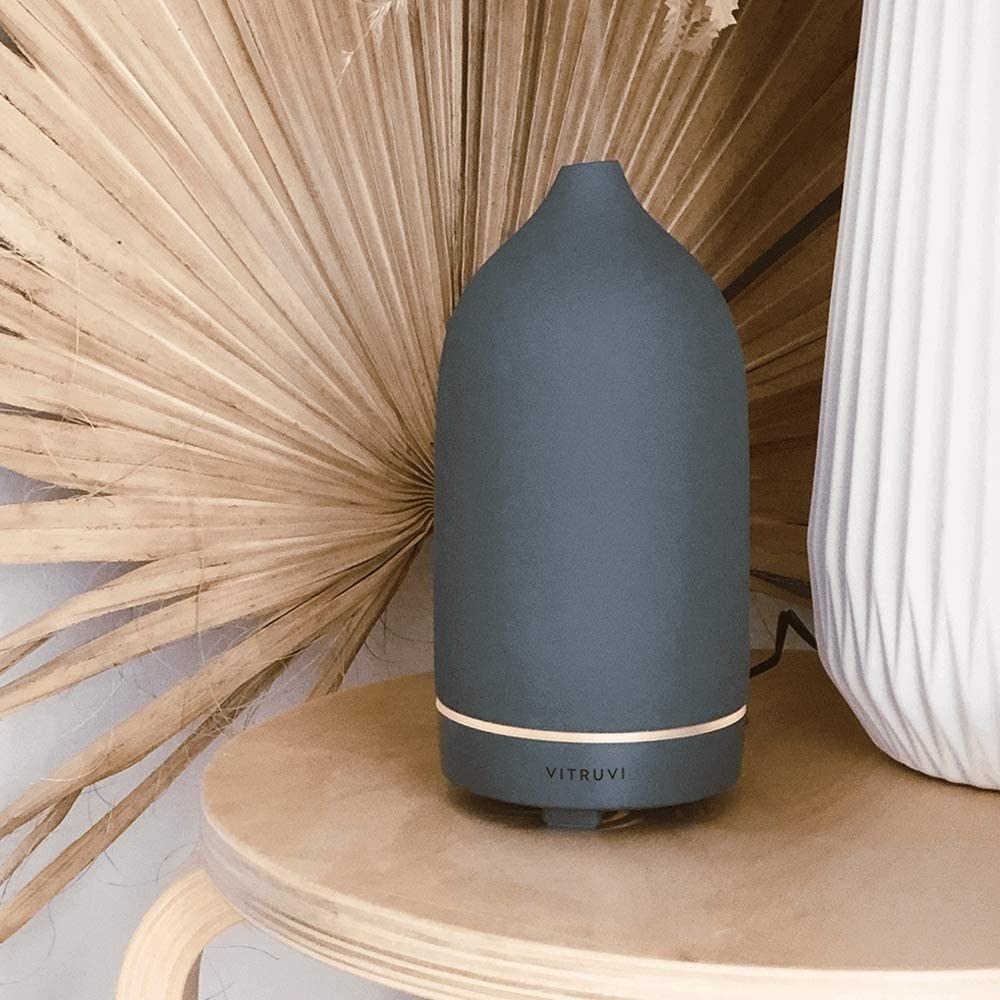 The oval-shaped diffuser with steam coming out of the top in dark grey