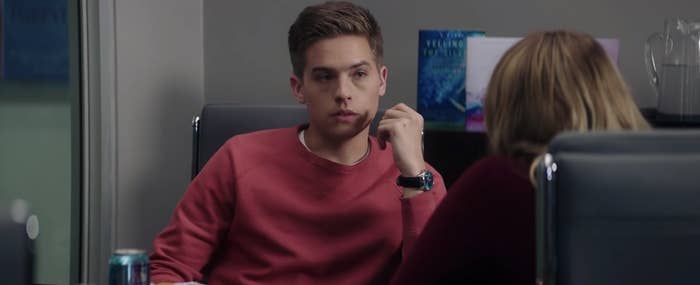 Trevor talking to Tessa in the conference room over dinner.