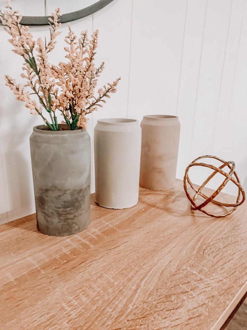 three concrete vases in different tones