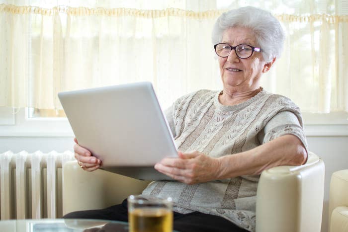 An old lady looking at a computer