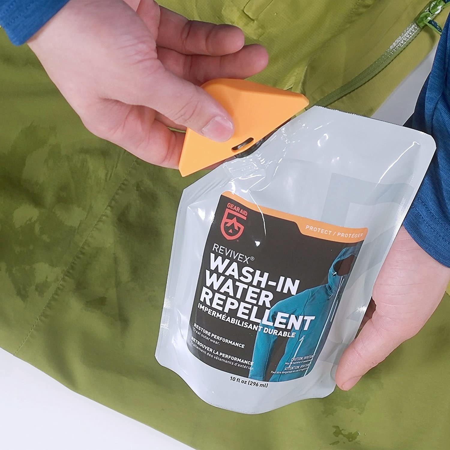 A person opening a packet of wash-in water repellant