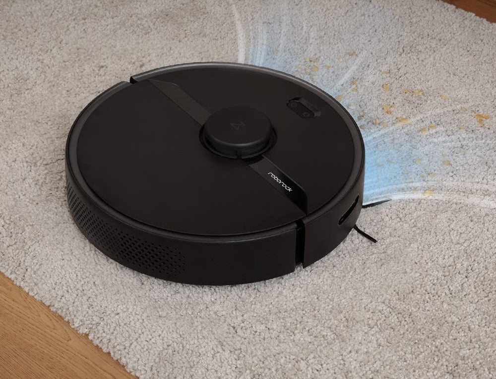 the black circular robot vacuum
