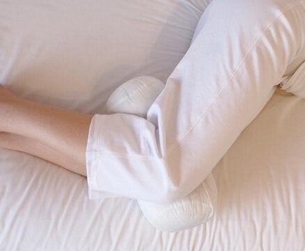 The knee pillow, which is cylindrical but has a indent in the middle, where your knees go