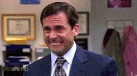 Michael Scott from "The Office" cringing.