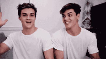 The Dolan twins high-fiving each other.
