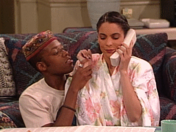 Dwayne kissing Whitley&#x27;s hand as she talks on the phone. 