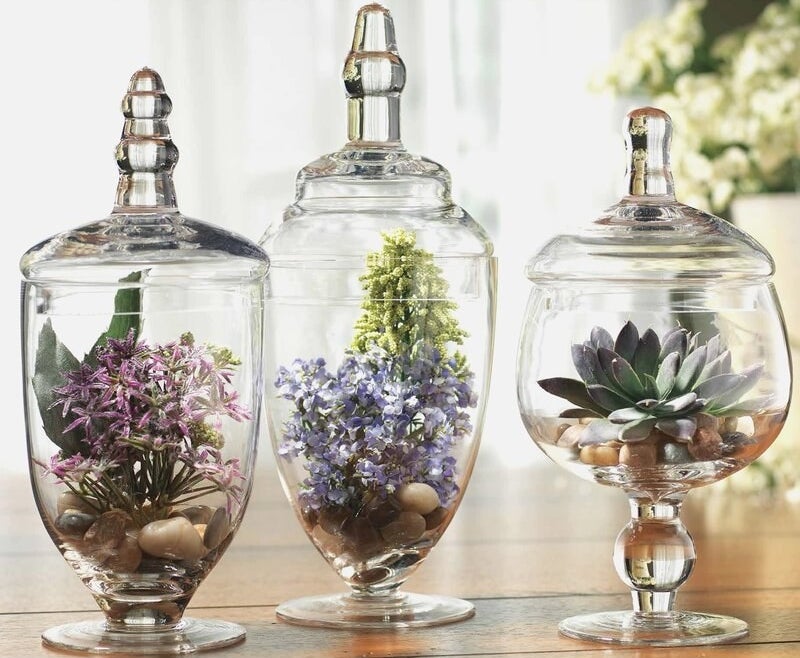 Apothecary jar set with colorful flowers inside