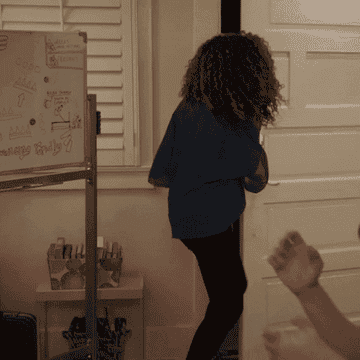 GIF of a woman running into a room with a bottle of wine and saying &quot;Your girl did it!&quot; 