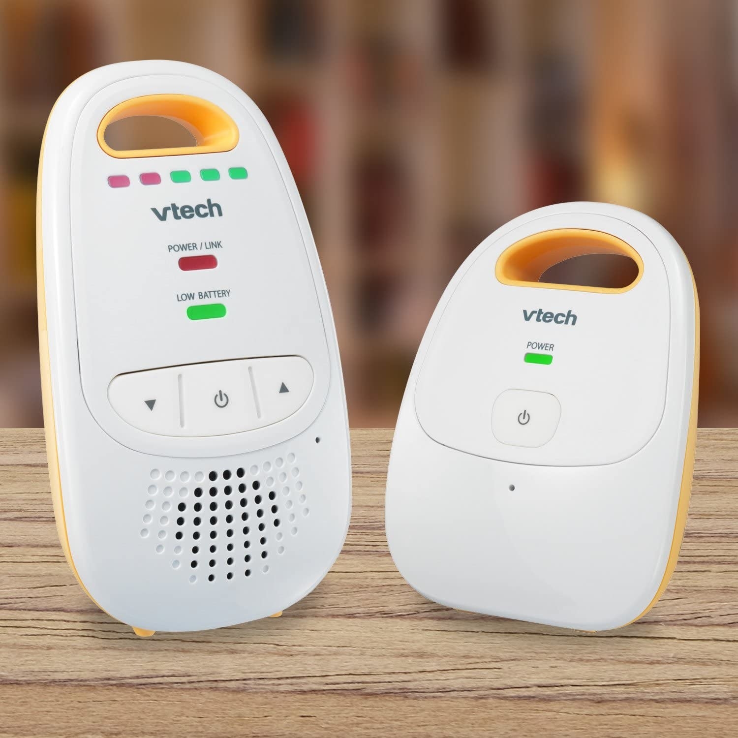 A round plastic baby monitor device with a walkie talkie next to it