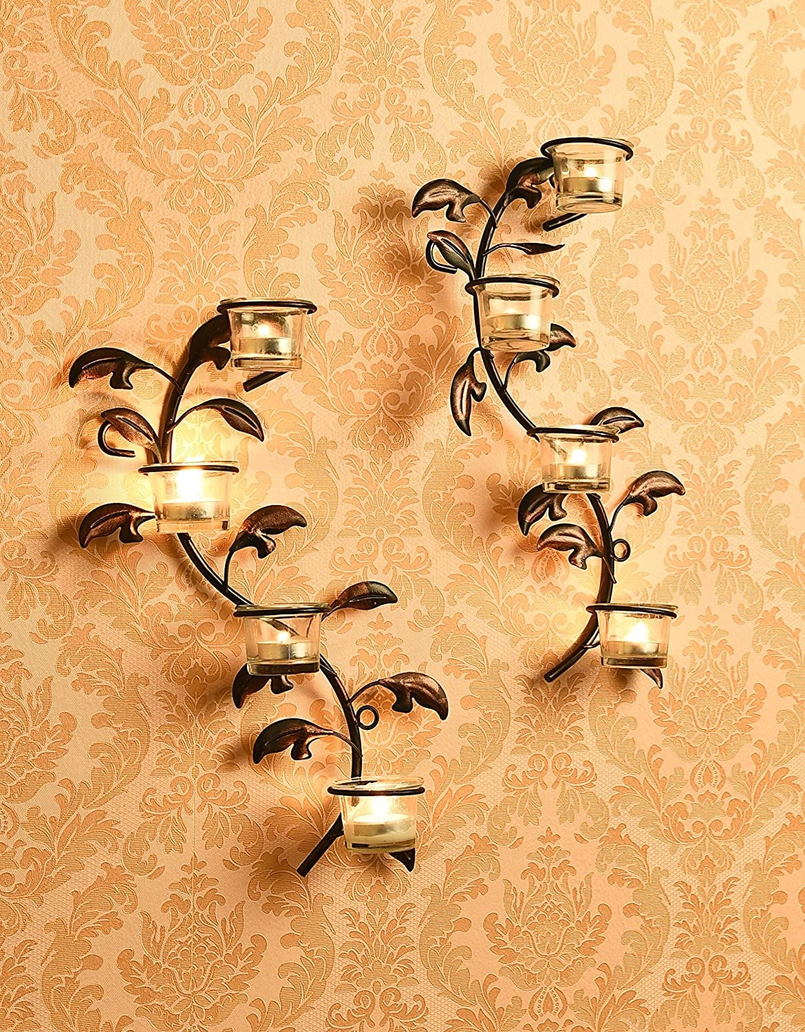 Brown wall sconces shaped like vines of flowers and leaves