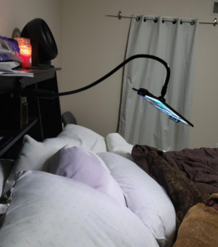 a reviewer's mount set up so they can watch tv in bed