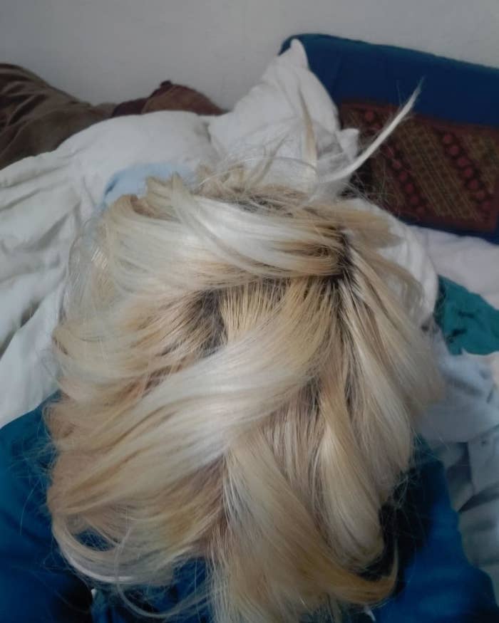 A reviewer shows their bleached blonde hair 