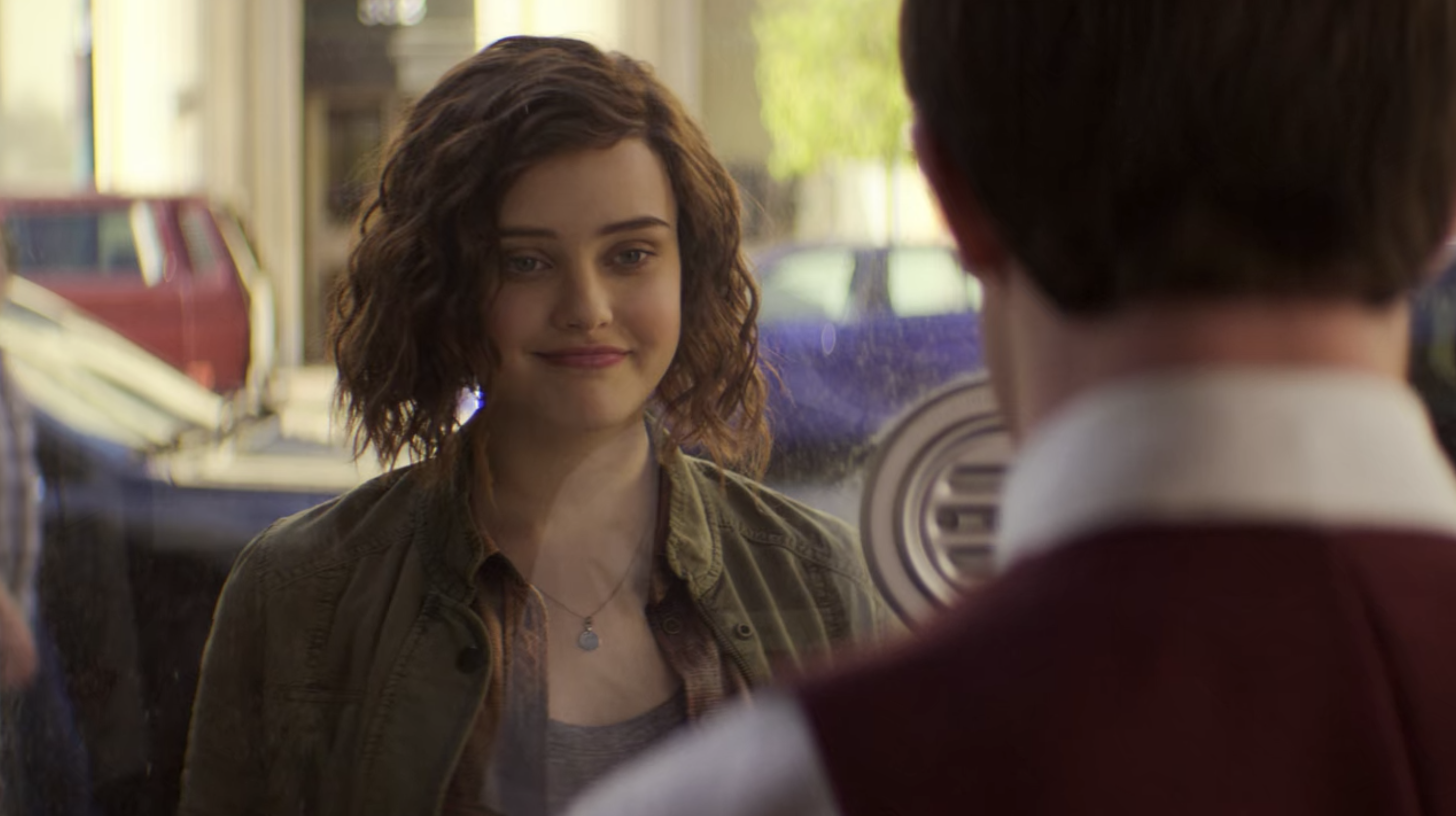 Katherine Langford in a short, stringy bob wig