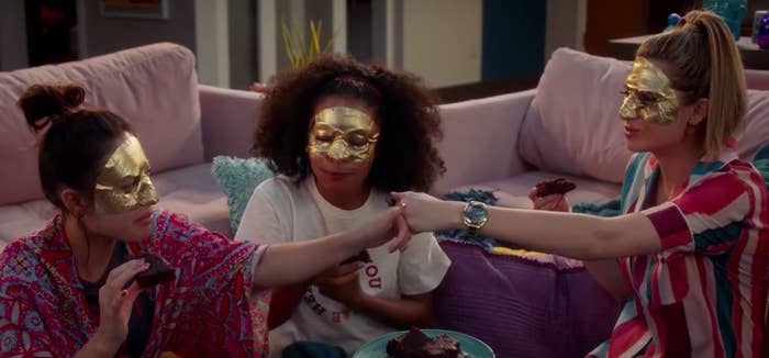 Anna, Zoey, and Nomi from "Grownish" wearing face masks and eating brownies.