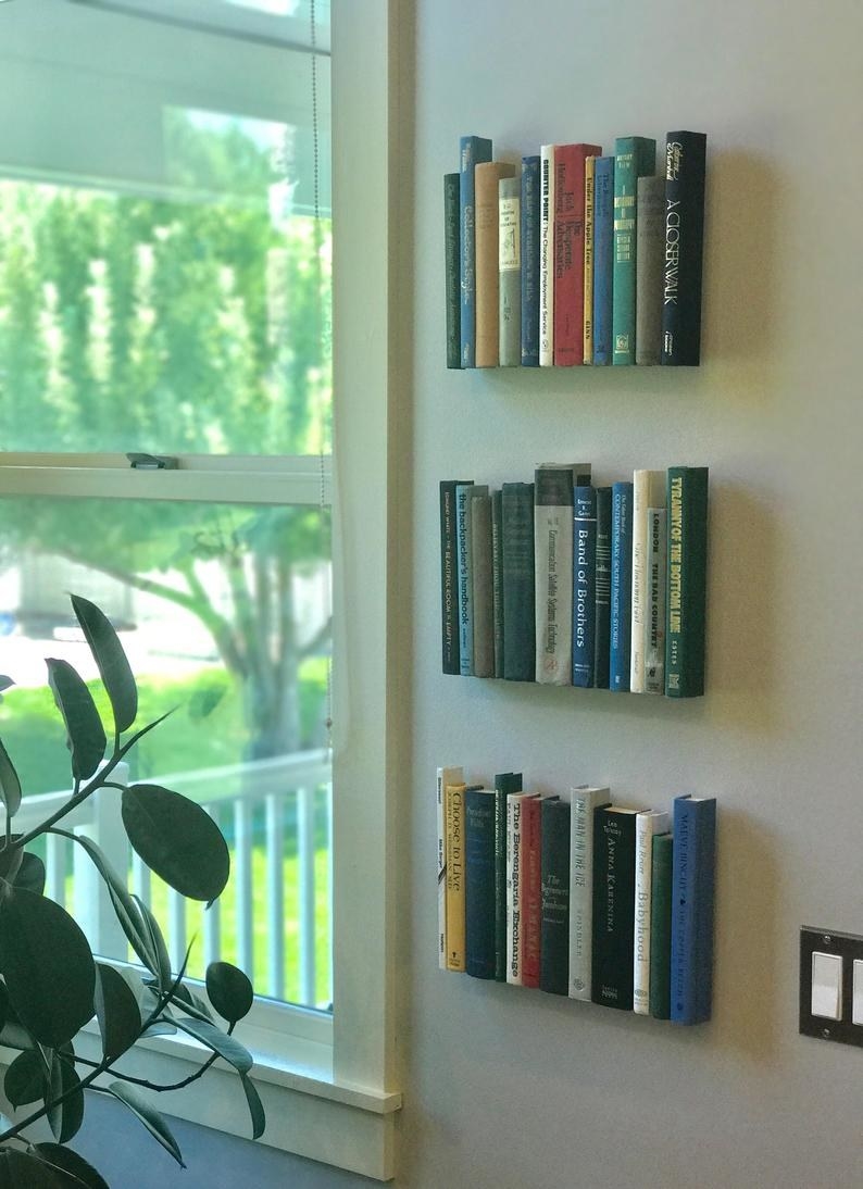 Three layers of book spines on the wall 