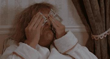 Harry from Dumb and Dumber wipe his face with dollar bills