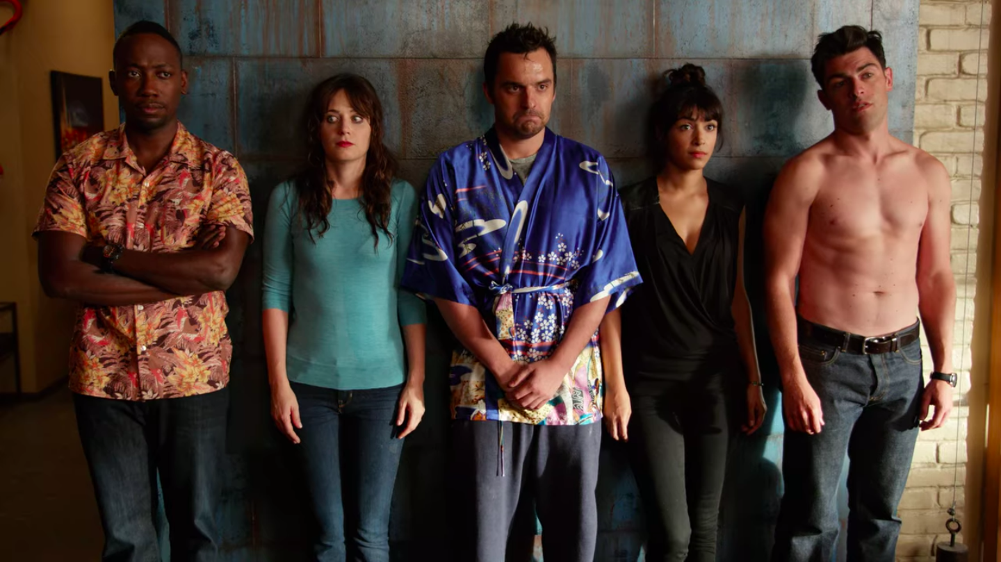 New Girl characters Winston, Jess, Nick, Cece and Schmidt standing against a wall