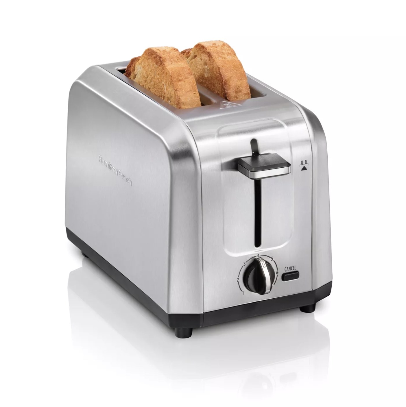 The silver toaster with toast in the slots