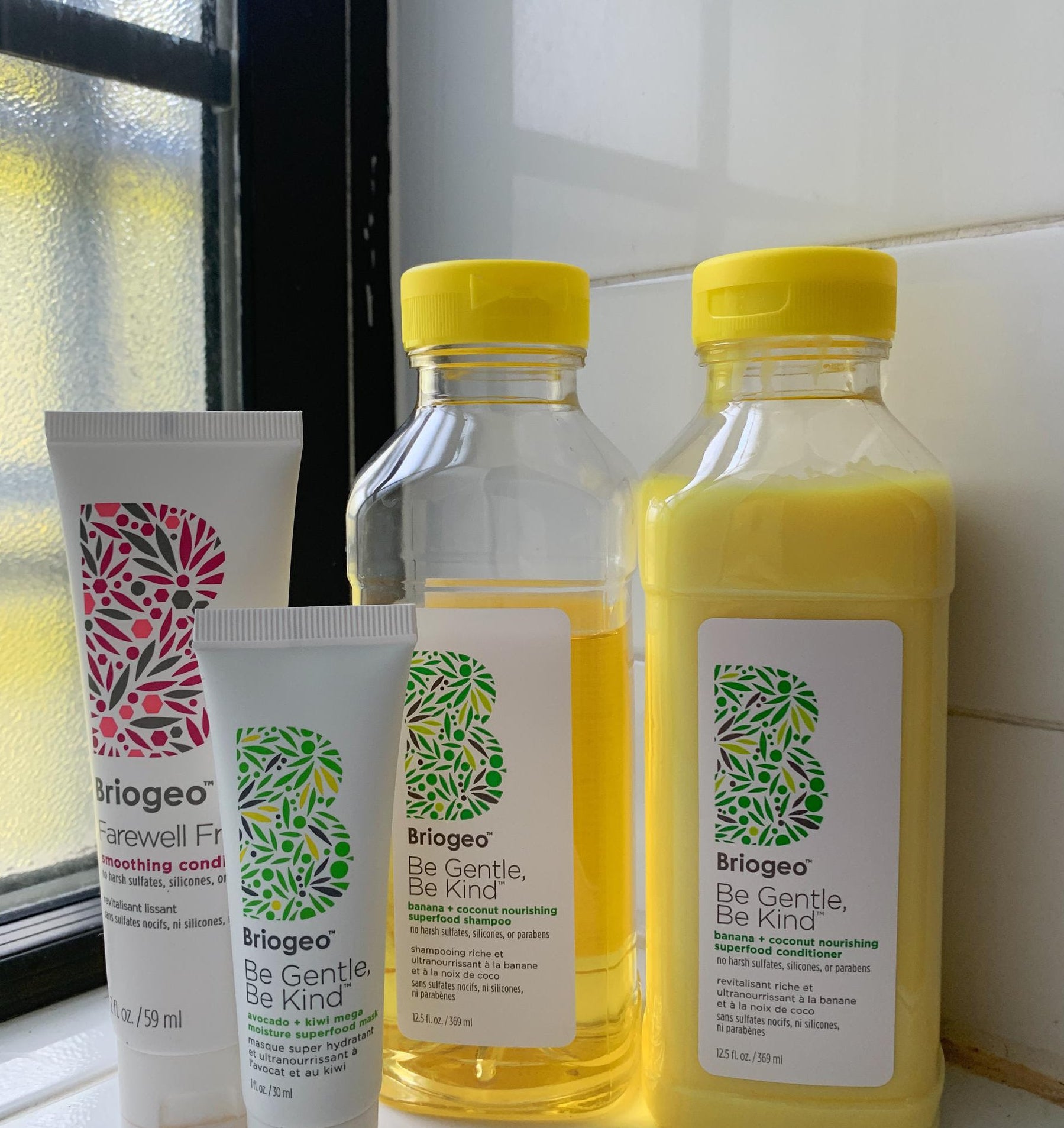 large bottles of yellow shampoo and conditioner with 2 other briogeo products