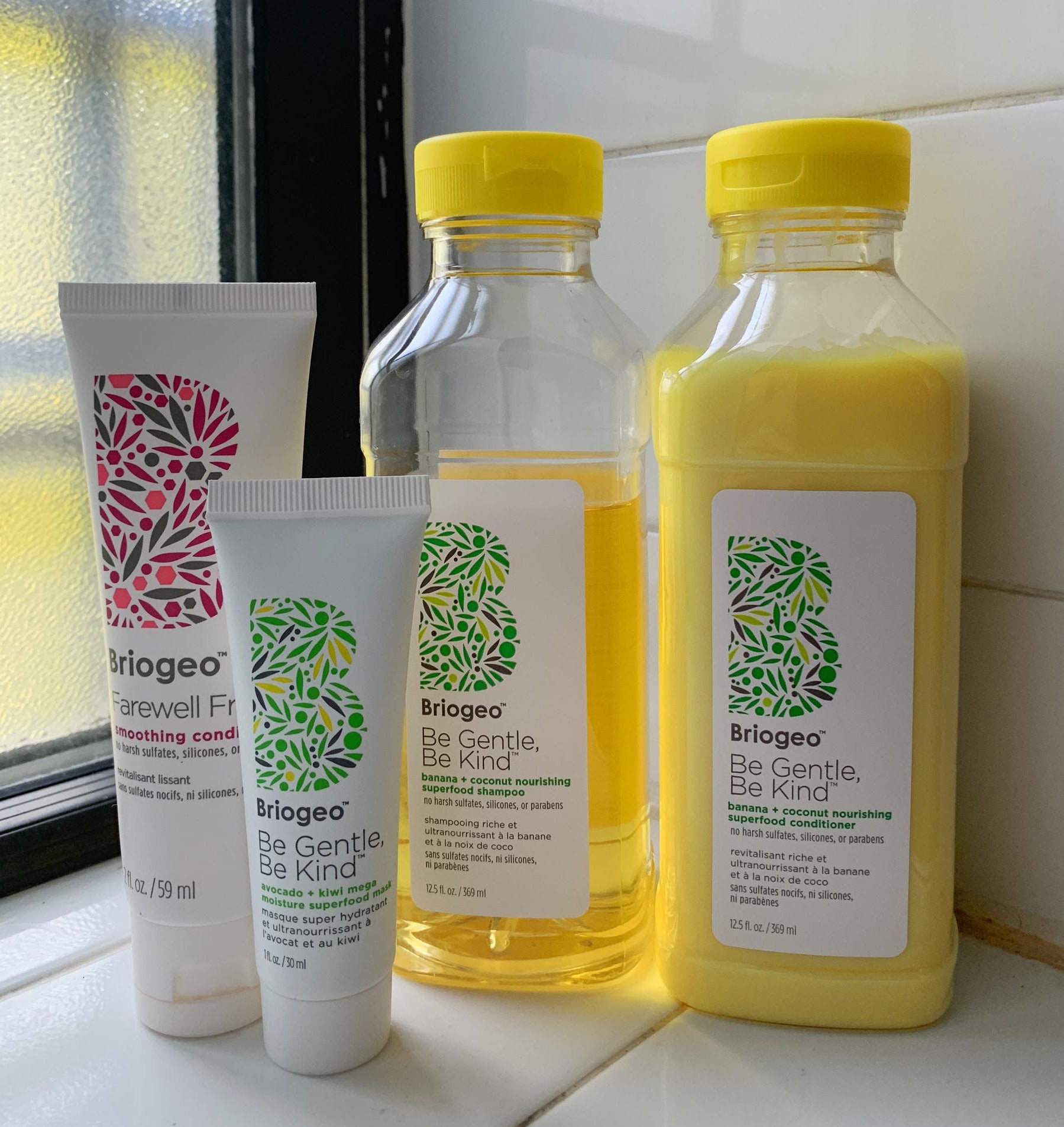 large bottles of yellow shampoo and conditioner with 2 other briogeo products