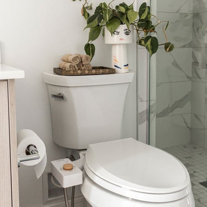 a white toilet seat with the white bidet and bamboo knob attached