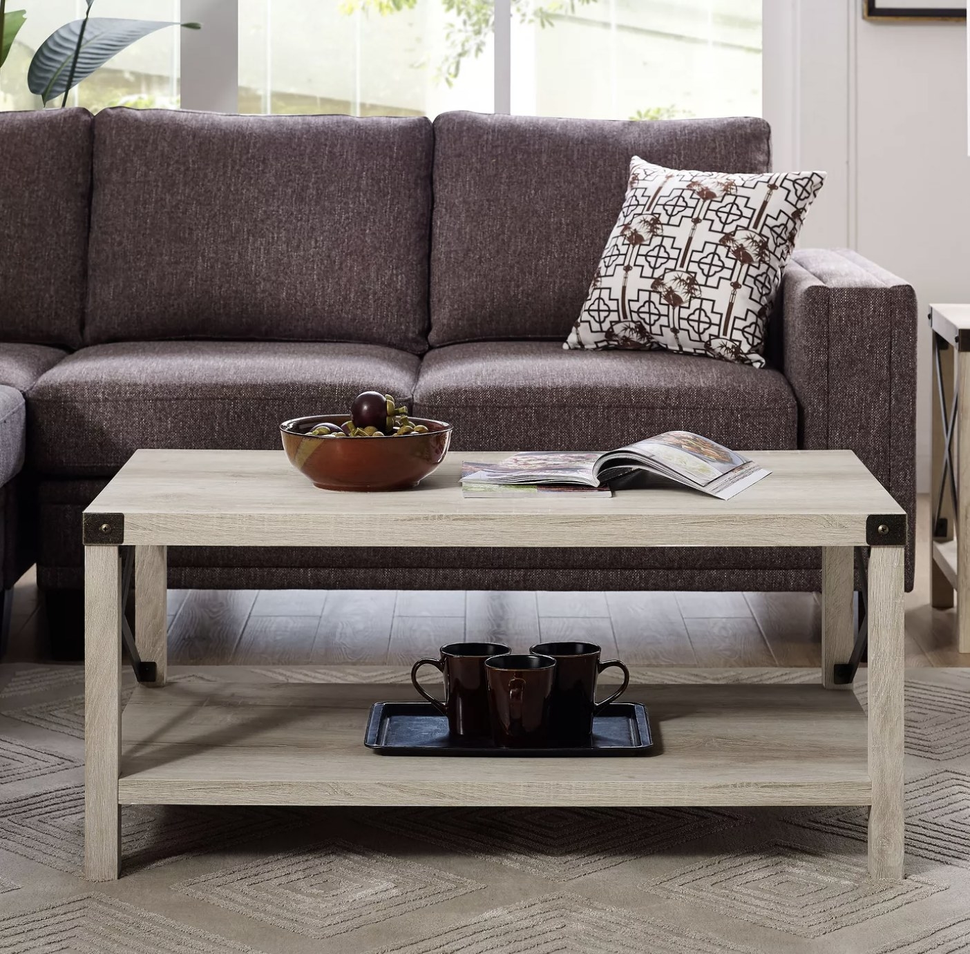 A light wood coffee table with decor on top in a living space