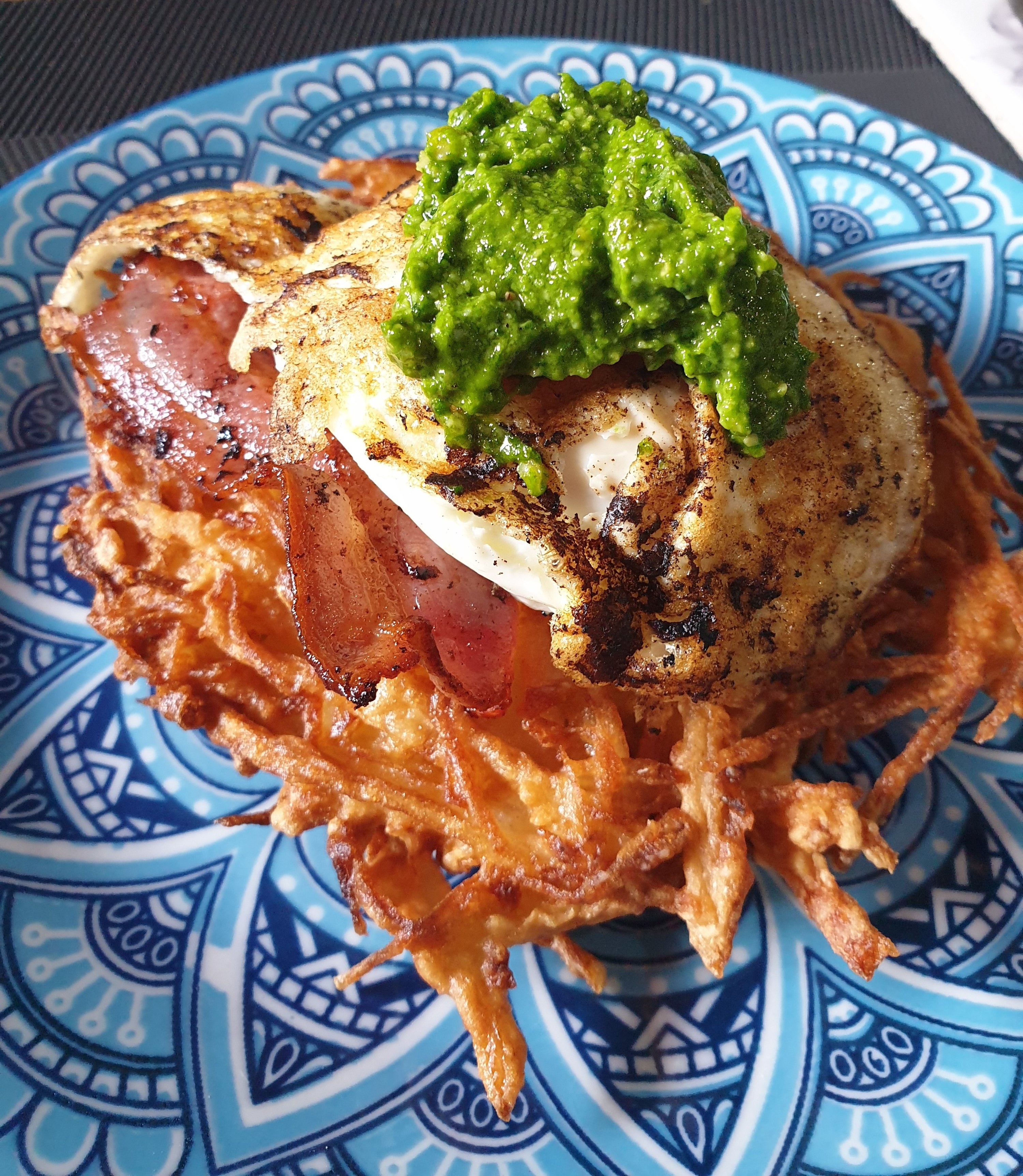 Home made hash brown with bacon, egg and home made pesto