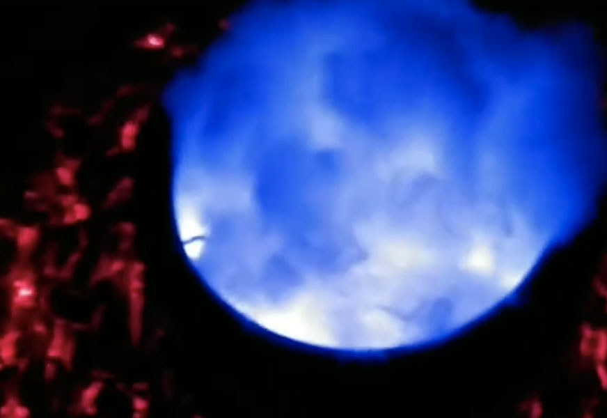 A cauldron glows blue in the dark