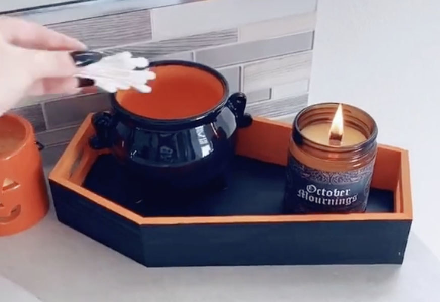 A tray shaped like a black and orange coffin 