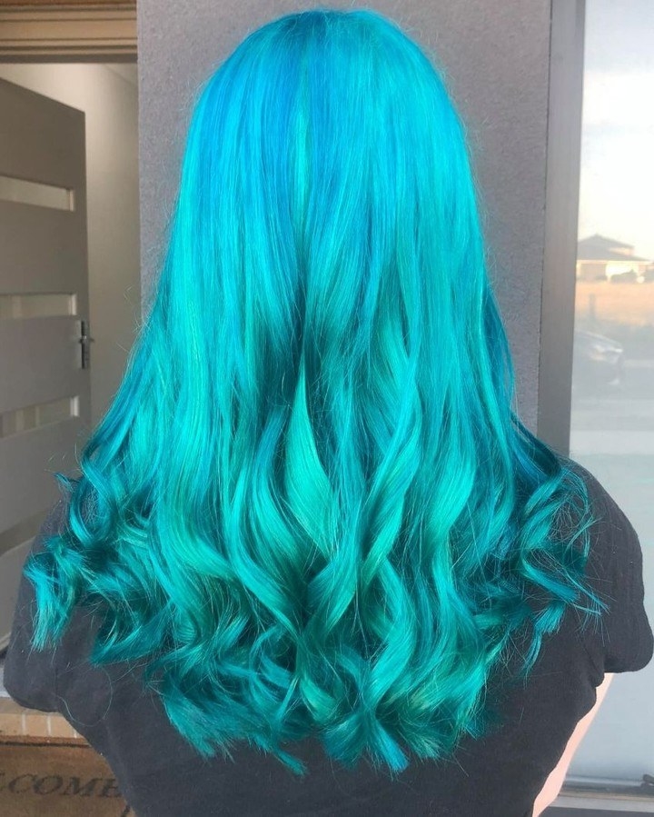 A model&#x27;s hair curled and blue after using voodoo blue dye