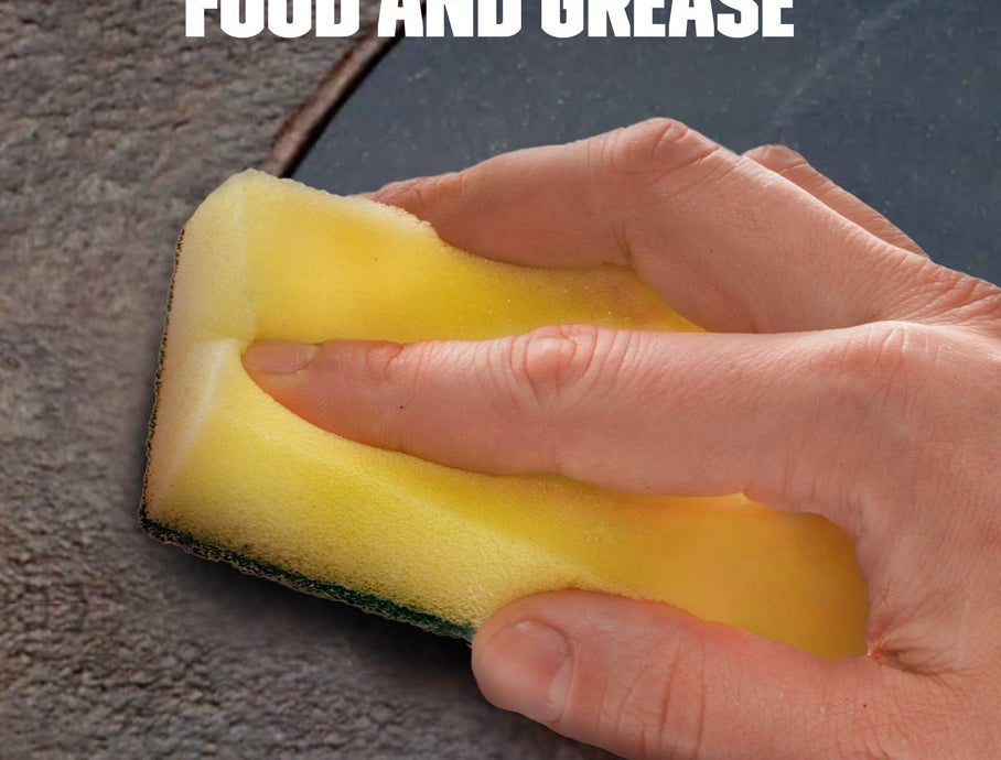 A sponge wiping away dirt after using the spray