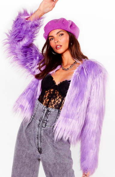 A person wears a shaggy purple jacket