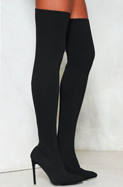 A person wears a pair of thigh-high boots