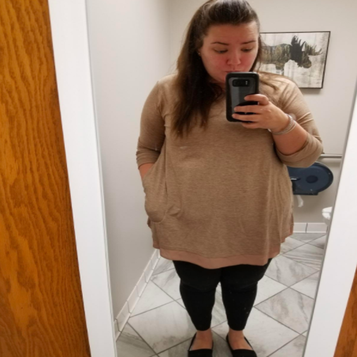 A reviewer wearing the top in light brown