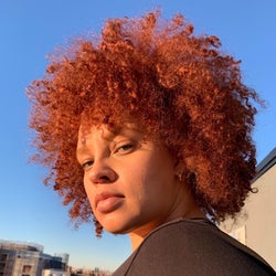 Reviewer showing off their red dyed natural hair